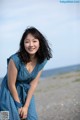 A woman in a blue dress posing for a picture.